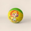 A green basketball with a purple cartoon dinosaur pattern printed on its surface, wearing a yellow headscarf with red dots, an orange outfit, and decorated with a small orange basketball and blue-green leaves details Picture